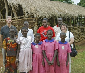 Iowa State representatives take a photo with Uganda children and adults