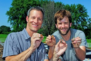 Fred Janzen and student hold up baby painted turtles