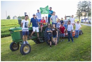 Students gather on top of an old John Deere tractor for the 37th International Association of Students in Agricultural and Related Sciences World Congress.