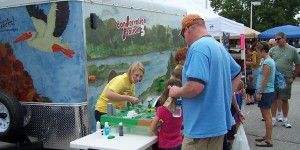 Rebecca Meerdink demonstrates land and water use on a model for kids at an event with Iowa Learning Farms this summer