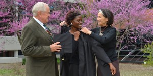 Chuck and Margo Wood help Becky Wokibula adjust her graduation gown