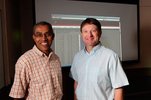 Rohan Fernando and Dorian Garrick pose in front of projector