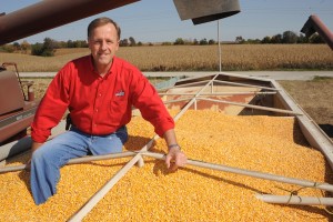 Chet Boruff sits in a wagon full of corn kernels during harvest