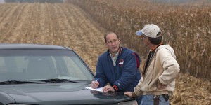 Farmer Mike Kniper meets with Iowa State Extension Specialist Chad Ingels in a field during harvest