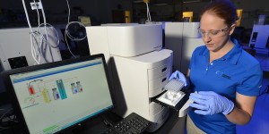 Katherine Hickman tests samples using a machine at Advanced Analytical Technologies in the ISU Research Park