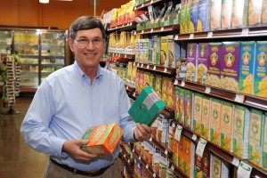 Wallace Huffman stands holds boxes of macaroni & cheese in an aisle at the grocery store