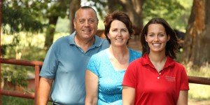 Elyssa McFarland is pictured on her farm with her parents by her side.