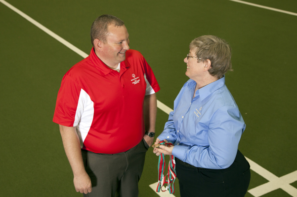 Matt Wenger visits with Kim Lively as members of the Special Olympics Summer Games committee.