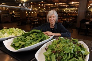 Helen Jensen poses at the salad bar in Seasons Dining Center on campus