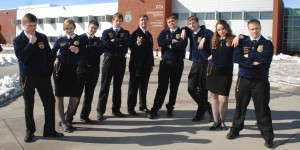 Teh 2013-14 Iowa FFA officer team dressed in official attire, jokingly pose outside the FFA Enrichment Center