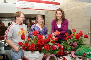 Barb Osborn, horticulture student advisor, helps students prepare bouquets of roses.