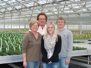 The Gooder family poses in their large greenhouse. The business of peddling plants has become a family affair.