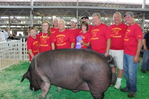 Iowa State alumni and friends gather for a picture wearing matching shirts with the 2014 Iowa State Fair Big Boar