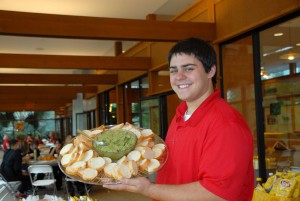 Culinary science student Phil Canada holds up a soy pesto dip with baguettes