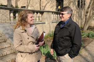 Katee Keller (senior) speaks with Director of Student Services Tom Polito outside by a building