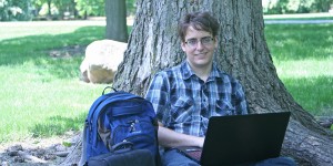 Shane Bugeja sits at the base of a tree studying
