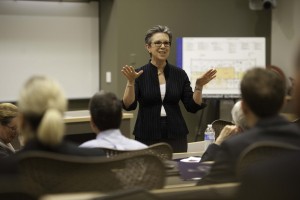 A professor presents to a group of fellow researchers