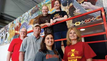 All hands were on deck in May for the installation of a mosaic mural Rich and Nancy Degner supported at the Jeff and Deb Hansen Agriculture Student Learning Center. Artist Clint Hansen (top left) had help from daughters Rachel (top right) and Rebekah (not pictured) and his wife Joni (bottom right). Former animal science chair Maynard Hogberg (bottom left), and facility manager Marshall Ruble and student employee Sarah Al-Mazroa also assisted. 
