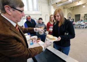 Don Beerman, chair of animal science, serves pancakes to current students in the Farm Bureau Pavilion.