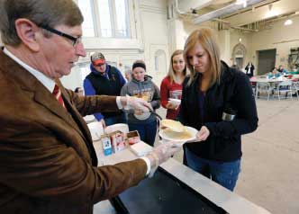 Don Beerman, chair of animal science, serves pancakes to current students in the Farm Bureau Pavilion. Among his priorities as chair is a revamp of the pavilion and strengthening international programs.