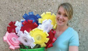 McKenzie Shaffer’s displays her art project made from ribbons she won from showing her horse.