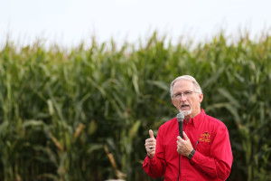 Speaker in front of corn field at Nutrient Reduction Strategies Field Day
