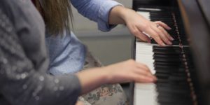 Iowa State student Marena Bartz instructs piano student Lindy Green, 11, during a lesson in Music Hall.