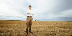 Andrew Lauver stands in field