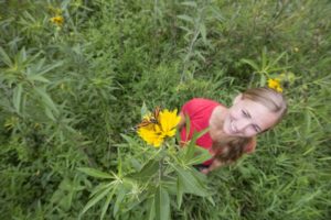 Kelsey Fisher releases a monarch butterfly on a prairie blossom.