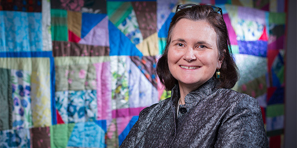 Headshot of Dr. Jo Anne Powell-Coffman with a quilt as the backdrop.