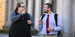 Kody Olson, left, who served as a communications intern for First Lady Michelle Obama, walks campus with his sign language assistant, Megan Johnson.