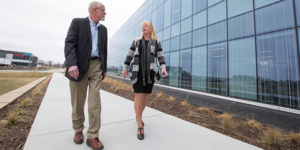 Steven Carter and Lisa Lorenzen walk outside the Economic Development Core Facility at the ISU Research Park.