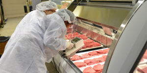 Kevin Keener (left) and Darren Jarboe analyze meat in retail displays.