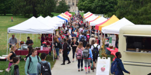 Crowd of students go to vendors along Curtiss to Beardshear walkway