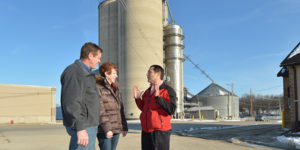 Steve Johnson discusses with and Jeff Cheryl Bruene at grain coop
