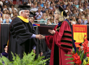 Jon Kinzenbaw receives an honorary Doctor of Science degree from ISU President Wendy Wintersteen.