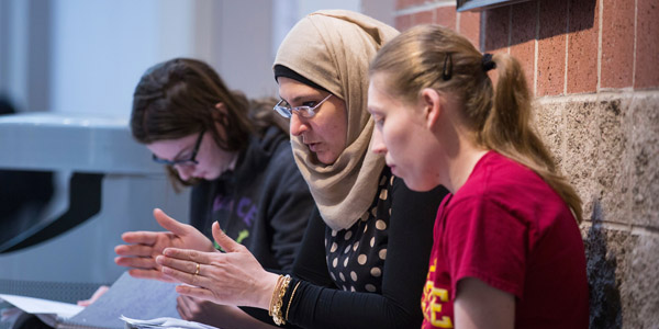 Genetics student Shemaa Albayati discusses material with fellow peers