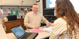 Ben Chamberlain advises a student in his office