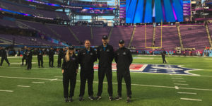Four Iowa State Alums stand in the middle of US Bank Stadium in Minneapolis for Super Bowl LII.