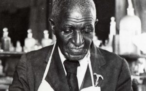 Black and white image of George Washington Carver as he works in a lab