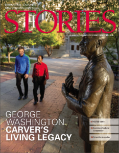 Cover of magazine showing to people - an African American professor and a caucasian student walking past a statue of George Washington Carver