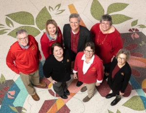 CALS communication team poses on the terrazzo floor of Curtiss Hall.
