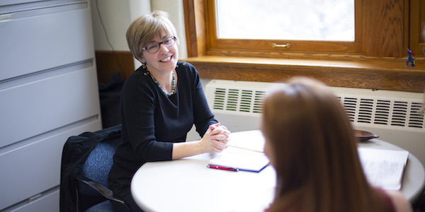 Dr. Carmen Bain meets with a student in her office